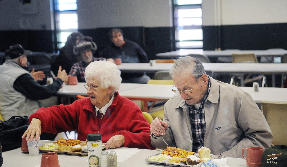 Rita Doyon, 82, and Burt Poulin, 94, eat lunch at the Winthrop Hot Meals Kitchen at the St. Francis Parish Hall in Winthrop on Monday. The kitchen recently had to discontinue lunch on Fridays because of a shortage of volunteers.
