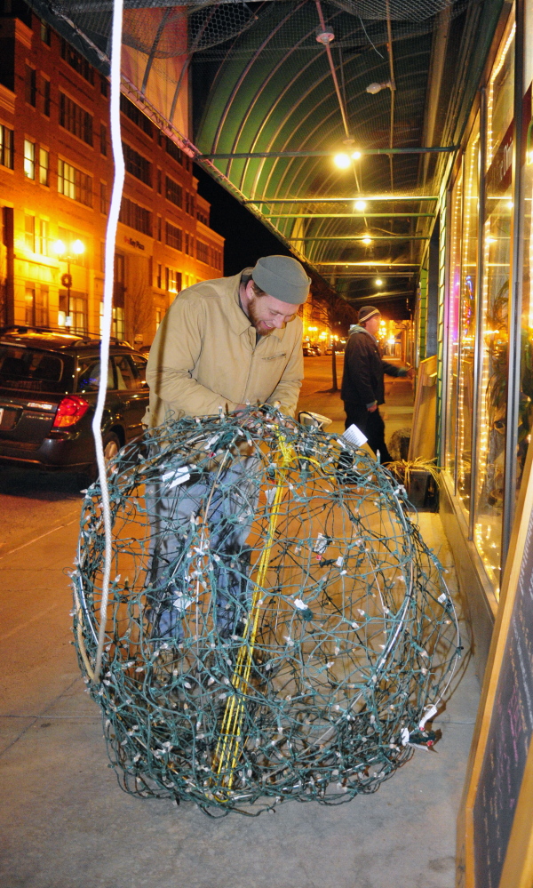 Jason McFarland prepares the New Year’s Eve ball on Tuesday at Gagliano’s Bistro on Water Street in Augusta.