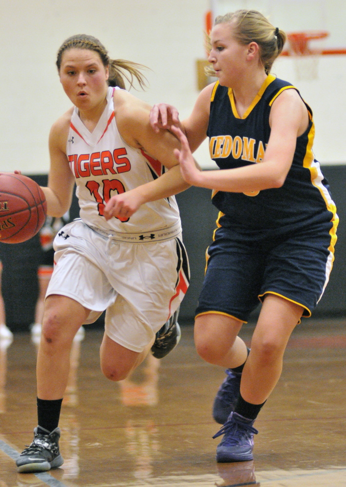 Gardiner’s Morgan Carver, left, tries to get past Medomak Valley’s Gabby DePatsy during a game Tuesday in the John A. Bragoli Memorial Gym at Gardiner Area High School.
