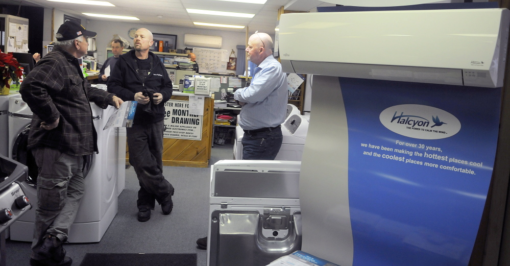 Dave’s Appliance co-owner Mike Ketchen, center, confers with customer Larry Labreck, left, and salesman Ed Pritchard at the Winthrop appliance store on Dec. 23. Labreck was shopping for a heat pump. Ketchen owns the business with his brothers, Scott and Brian.
