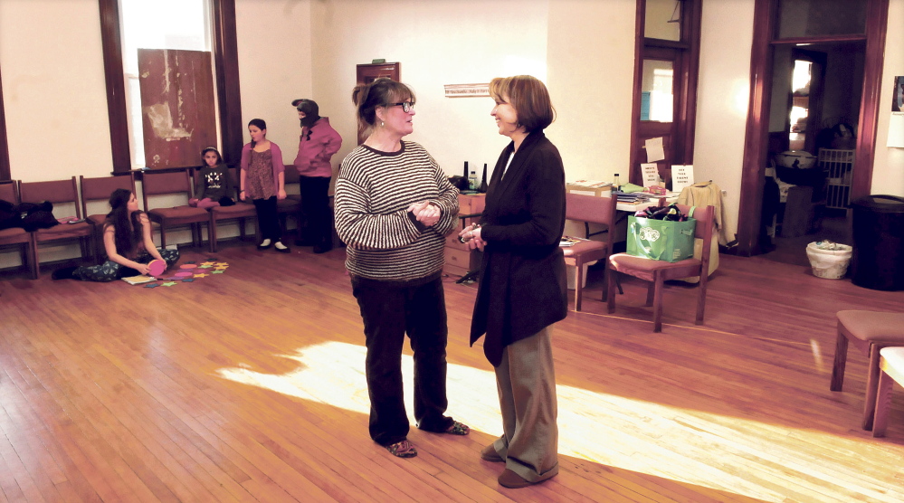 Children’s Cottage business owner Karen Lewia, right, speaks with tenant Midge Pomelow, of Midge’s Theater Arts Studio, in the Skowhegan building where Lewia intends to offer space to other businesses in 2015.