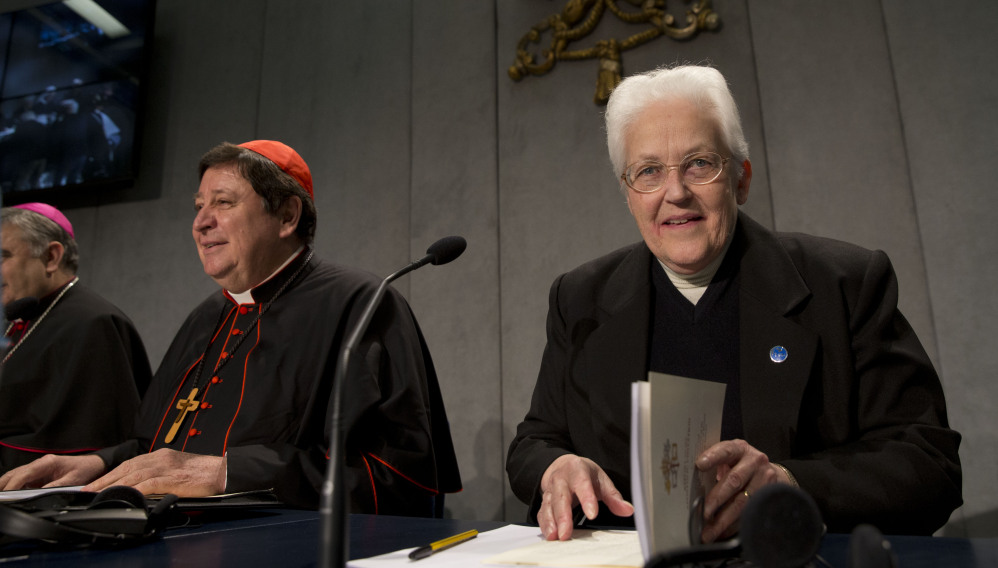 Sister Sharon Holland, right, arrives for a news conference at the Vatican on Tuesday. The Associated Press