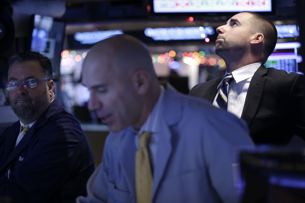Traders work on the floor at the New York Stock Exchange in New York on Thursday. Even the energy sector advanced, despite another drop in the price of oil, as bullish earnings from the technology giant Oracle help drive the rally.  The Associated Press