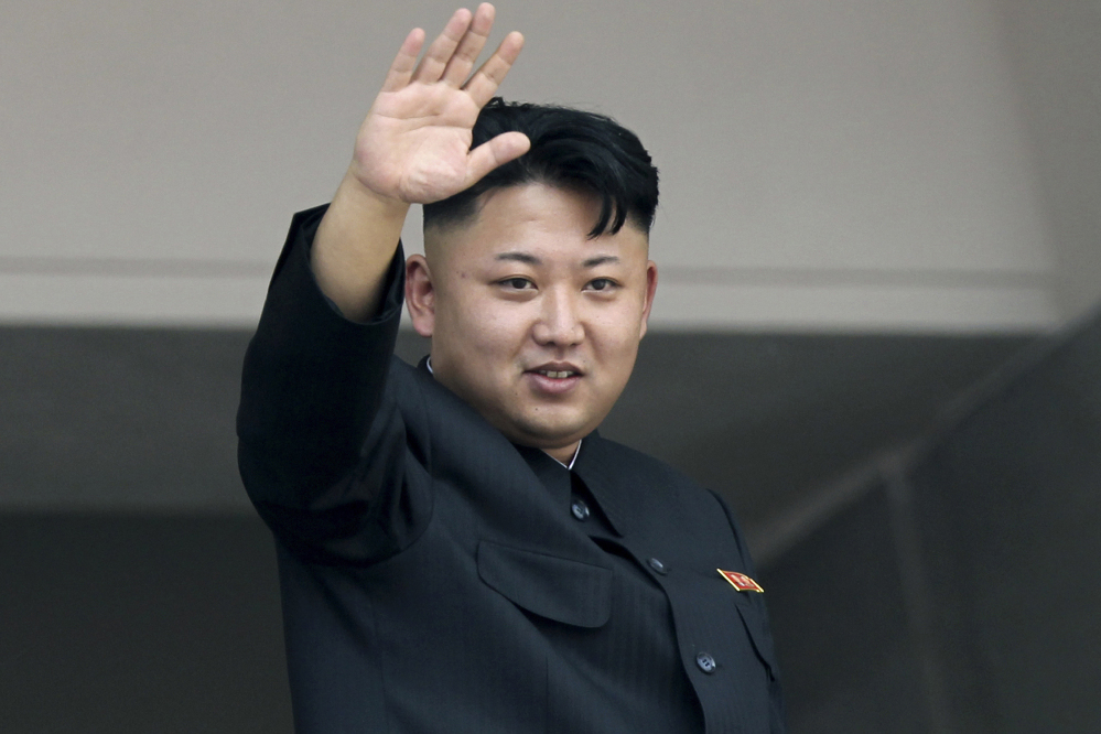 North Korea’s leader Kim Jong Un waves to spectators at a military parade. The Associated Press