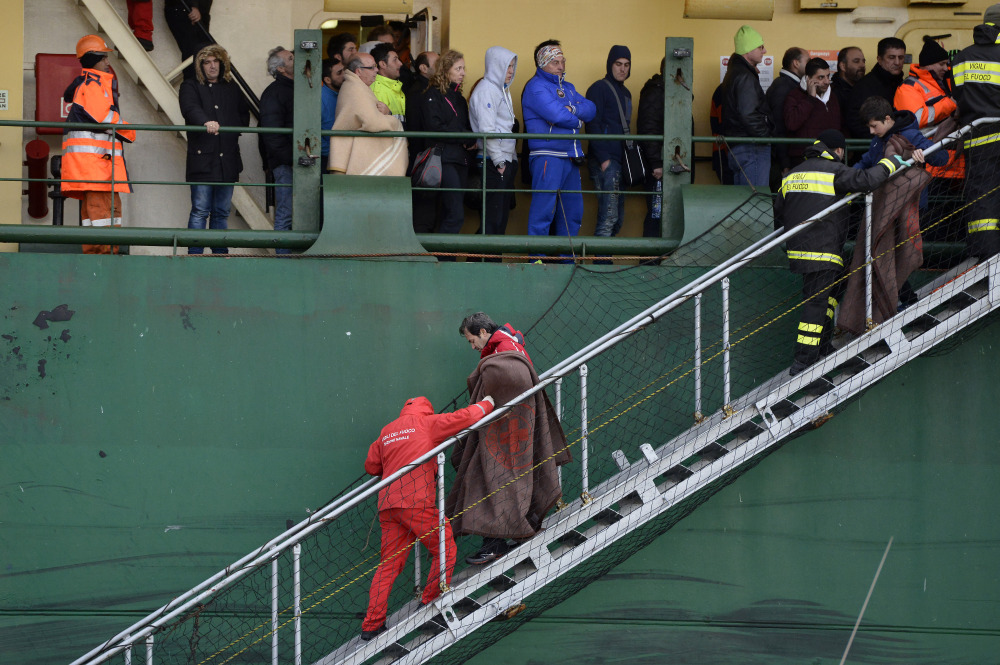 Passengers and crew of the Italian-flagged Norman Atlantic, that caught fire in the Adriatic Sea, disembark from a ship in Bari harbor, southern Italy, Monday. The Associated Press