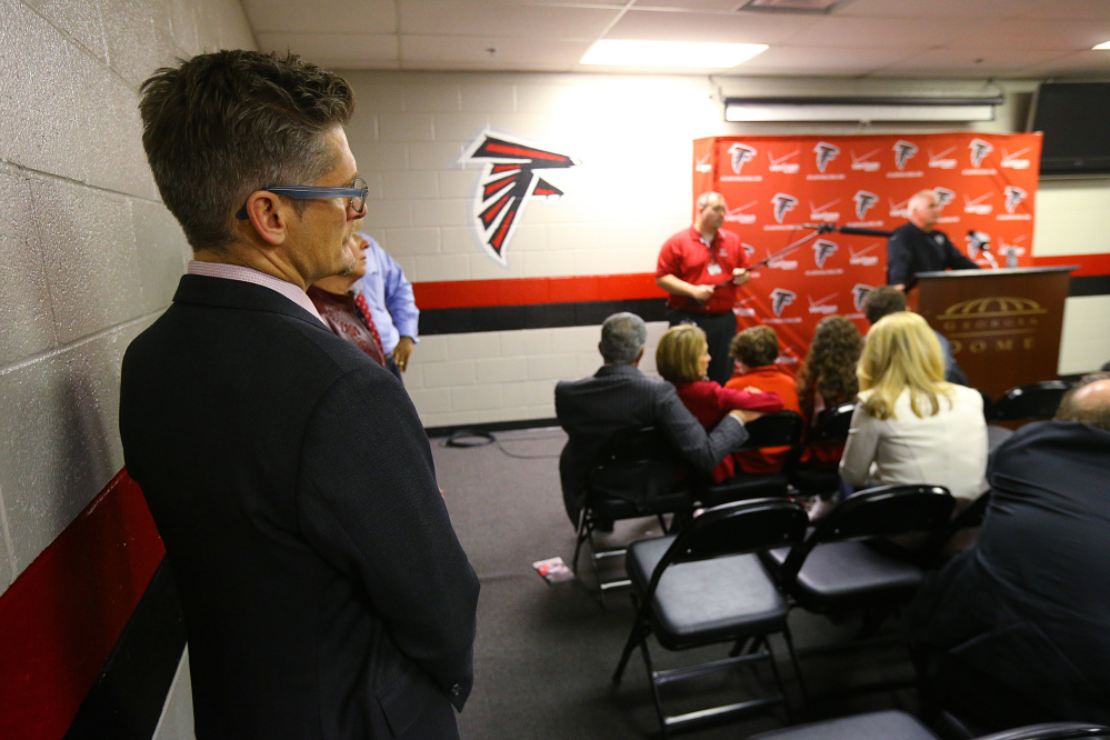 Atlanta Falcons general manager Thomas Dimitroff, left, listens to coach Mike Smith during a news conference after the Carolina Panthers defeated the Falcons 34-3 in an NFL football game Sunday, Dec. 28, 2014, in Atlanta. The Associated Press