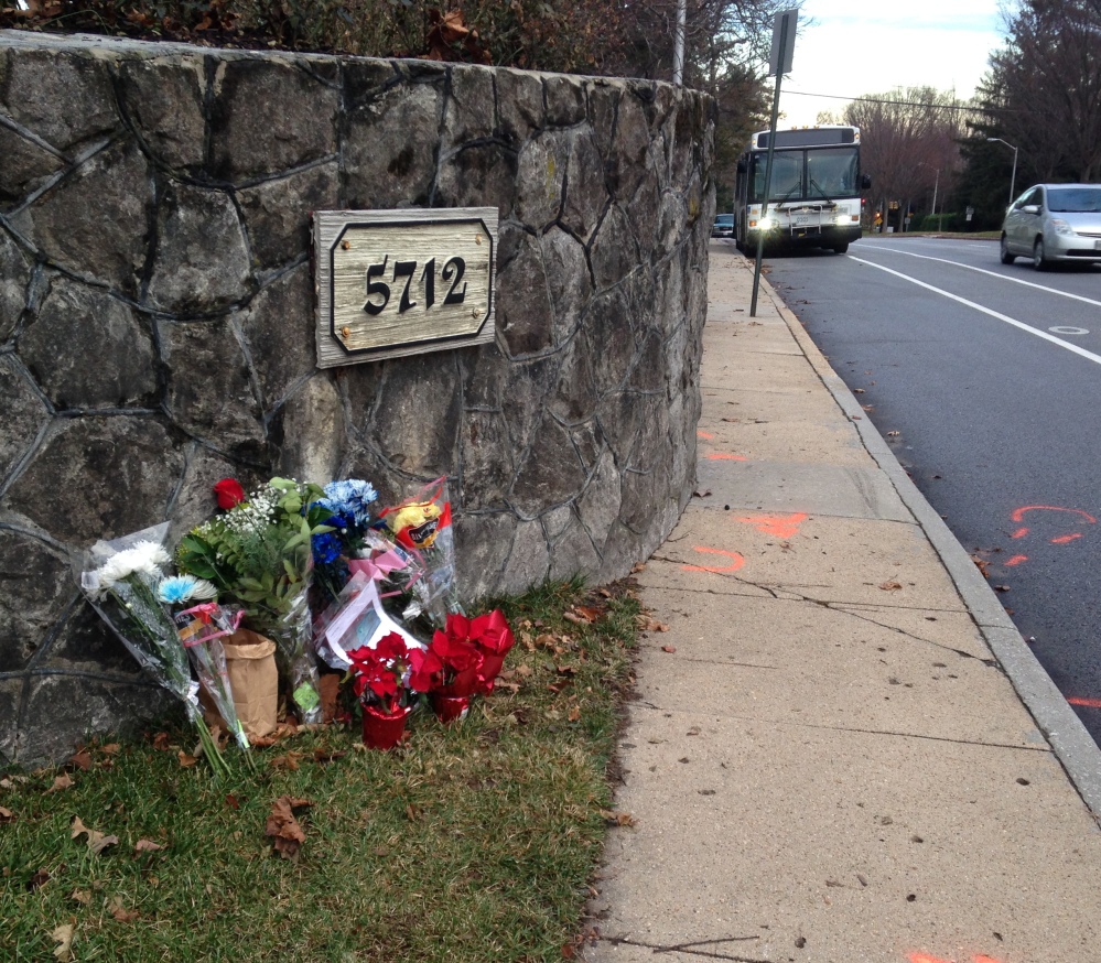Flowers mark the site where a bicyclist was hit Saturday in Baltimore. An Episcopal bishop returned “to take responsibility for her actions,” one of her peers says. The Associated Press