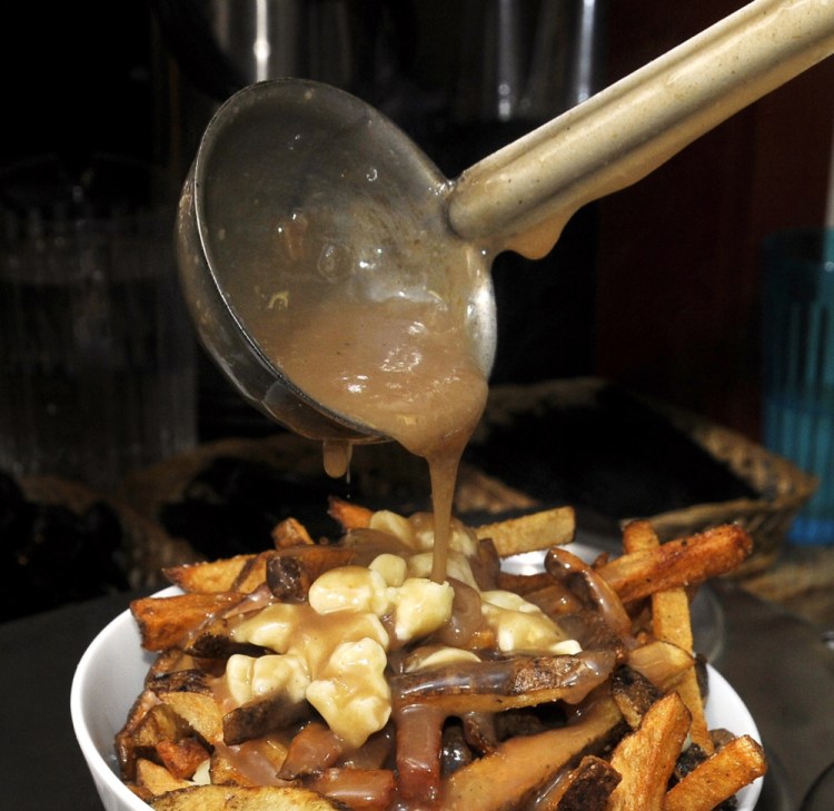 Duckfat's poutine begins with its signature fries, topped with cheese curds and gravy.
Gordon Chibroski/Press Herald File
