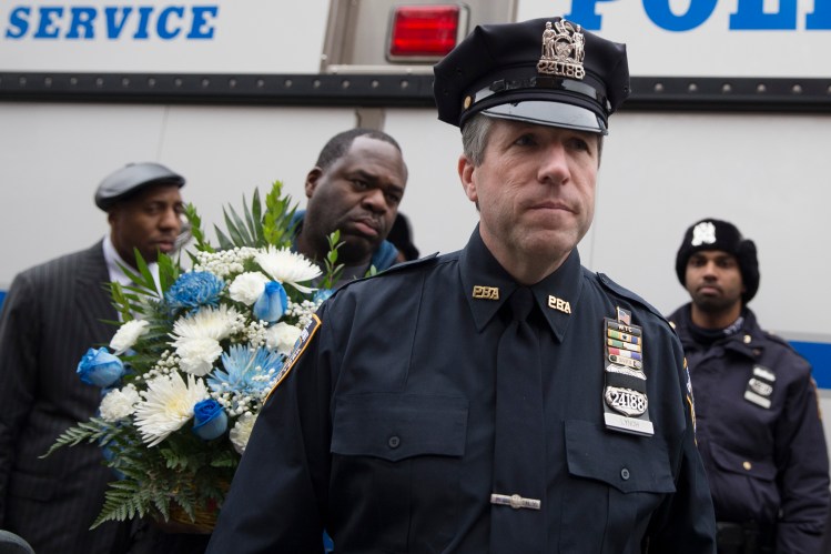 Patrick Lynch, president of the Patrolman's Benevolent Association, arrives at a makeshift memorial near the site where New York Police Department officers Rafael Ramos and Wenjian Liu were murdered in the Brooklyn borough of New York. The Associated Press