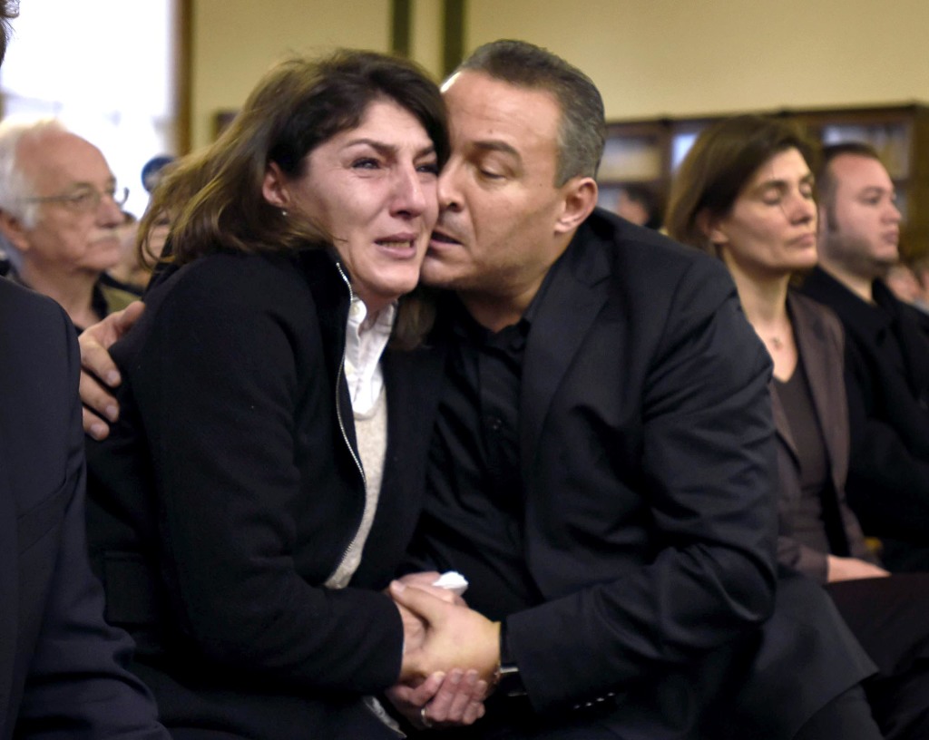 Gulcin and Celal Dede embrace after Markus Kaarma was found guilty of deliberate homicide, Wednesday, Dec. 17, 2014, in Missoula County District Court in Missoula, Mont., in the shooting death of their son Diren Dede, a foreign exchange student from Germany. The Associated Press