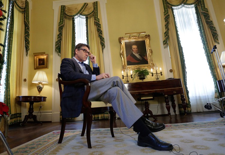 Texas Gov. Rick Perry answers questions during an interview at the historic Texas Governor's Mansion in Austin, Texas. The Associated Press