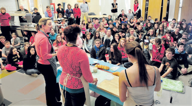 Students and staff members of Skowhegan Area Middle School watch as Amy Driscoll, left, of the King Arthur Flour Co., conducts a workshop on baking bread Tuesday at the school. Assisting are students Shaneka Sapienza, center, and Katelin Warren.