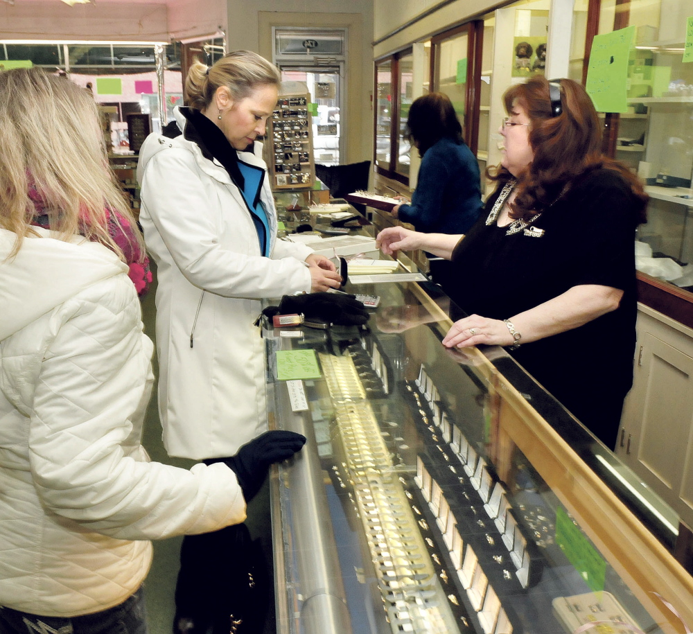 Trask Jewelers manager Beth Neeley, right, shows rings to customer Kathy Clark on Wednesday, the last day the Farmington business was open.