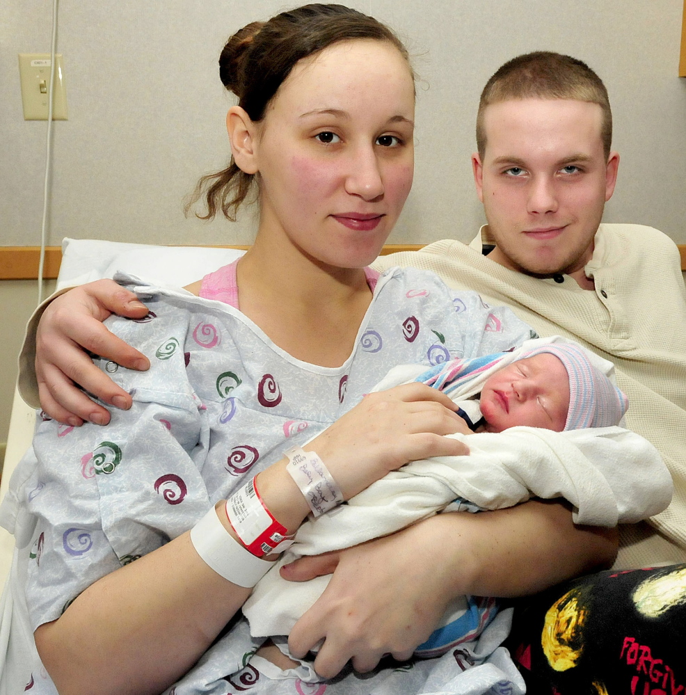 Kimberly Bellanceau holds her newborn son Adam, who was born Thursday at 9:52 a.m.,  at Franklin Memorial Hospital in Farmington, the hospital’s first baby of 2015. At right is father John Oberton.