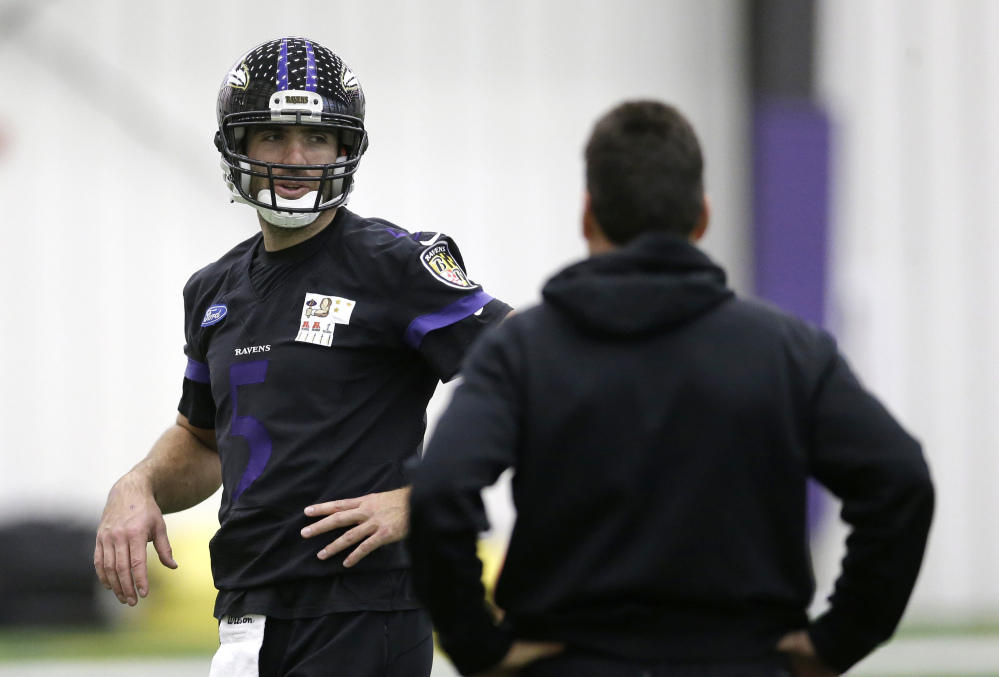 Baltimore Ravens quarterback Joe Flacco, left, chats with offensive coordinator Gary Kubiak during apractice Tuesday in Owings Mills, Md. The Ravens will travel to Pittsburgh for a Saturday wild-card game against the Pittsburgh Steelers.