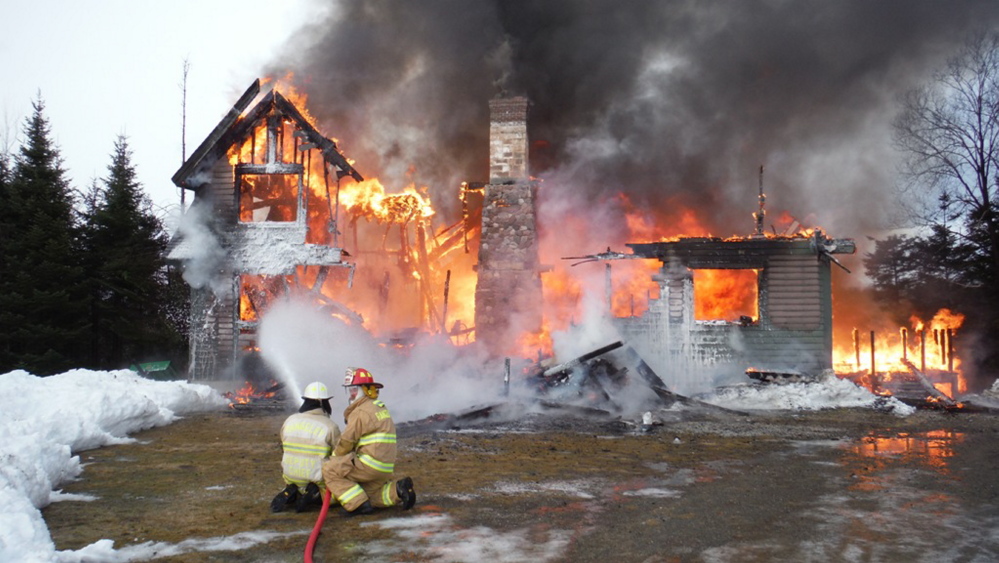 Rangeley Deputy Fire Chief Stephen Grant, left, seen with Captain Tony Clark shortly after arriving at a fire in Dallas Plantation on  New Year’s Day.