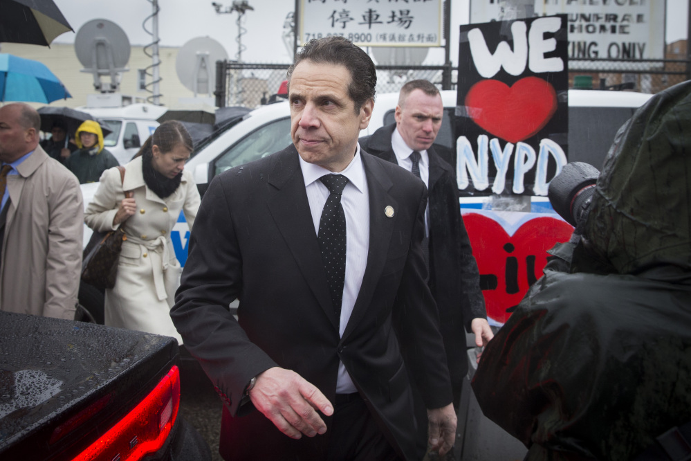 New York Gov. Andrew Cuomo leaves the wake of New York Police Department officer Wenjian Liu at the Aievoli Funeral Home, Saturday, in the Brooklyn borough of New York. Liu and his partner, officer Rafael Ramos, were killed Dec. 20 as they sat in their patrol car on a Brooklyn street.