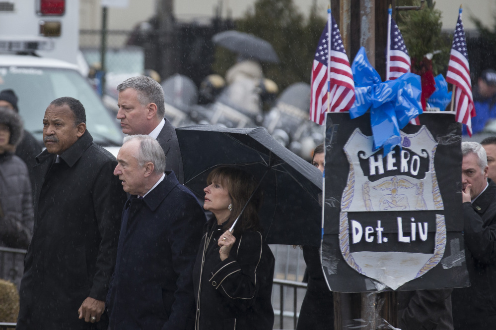 From left, 1st New York Police Department Deputy Commissioner Benjamin Tucker, New York City Mayor Bill de Blasio, upper, New York Police Department Commissioner Bill Bratton, and Rikki Klieman, Bratton’s wife, arrive at the wake of NYPD Officer Wenjian Liu at Aievoli Funeral Home, Saturday.