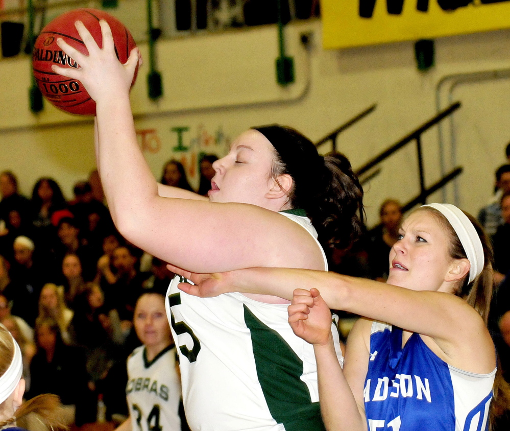 Carrabec’s Emma Pluntke, left, grabs ball from Madison’s Aly LeBlanc during Monday’s game in North Anson.