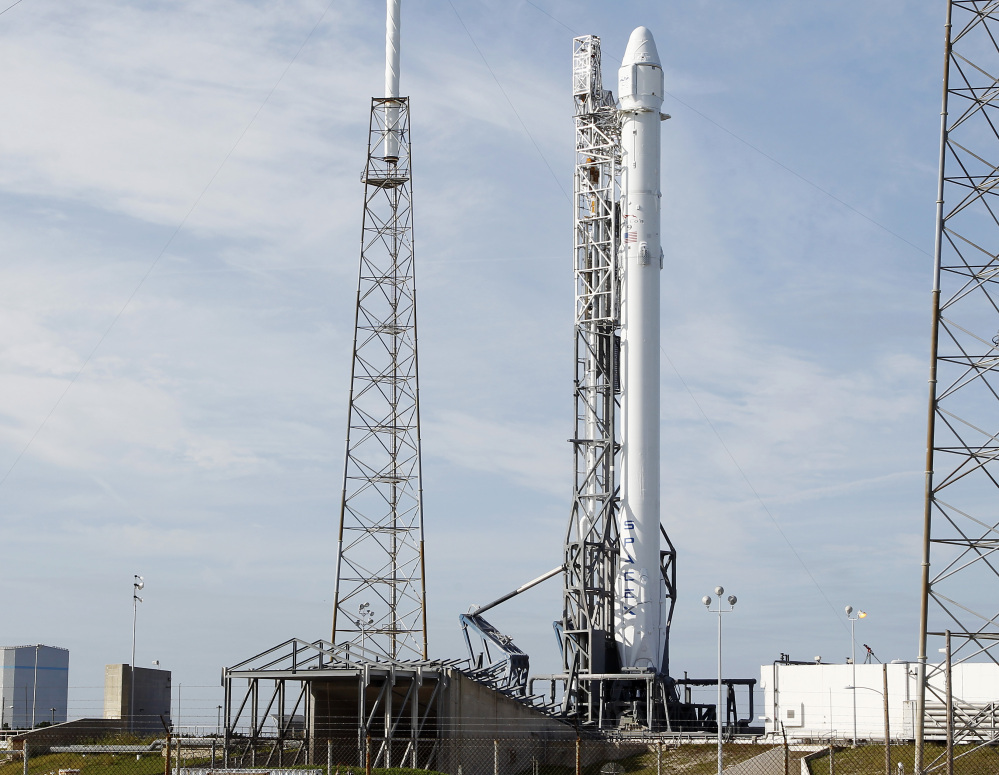 The Associated Press A Falcon 9 rocket carrying the SpaceX Dragon spacecraft is seen at launch complex 40 after an attempted early morning launch was scrubbed due to technical issues at the Cape Canaveral Air Force Station in Cape Canaveral, Fla. on Tuesday.