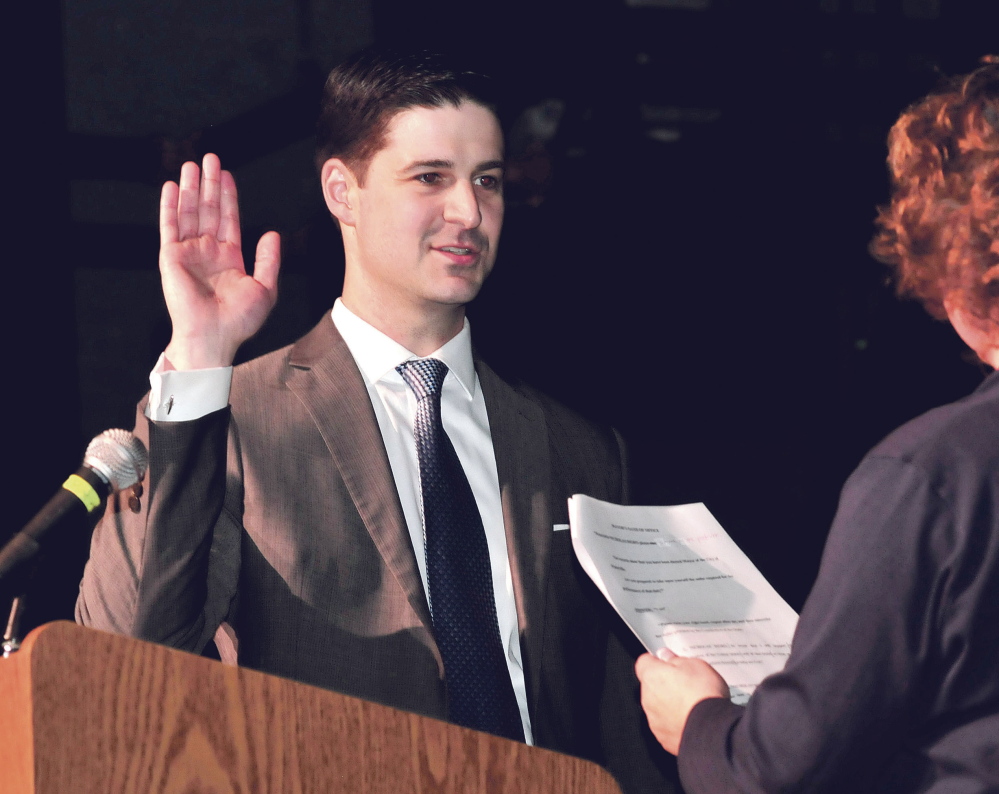 Newly elected Waterville Mayor Nick Isgro takes the oath of office administered by City Clerk Patti Dubois on Tuesday.