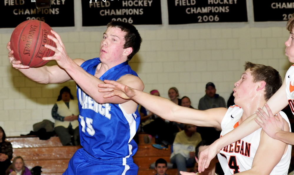 Lawrence’s Seth Powers, left, is blocked by Skowhegan’s Garrett McSweeney during game Tuesday in Skowhegan. Lawrence won 70-56.