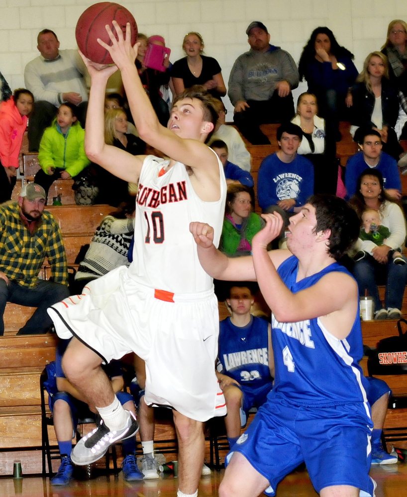 Skowhegan’s Kyle Dugas goes up with ball against Lawrence’s Kyle Robinson during a game Tuesday in Skowhegan.