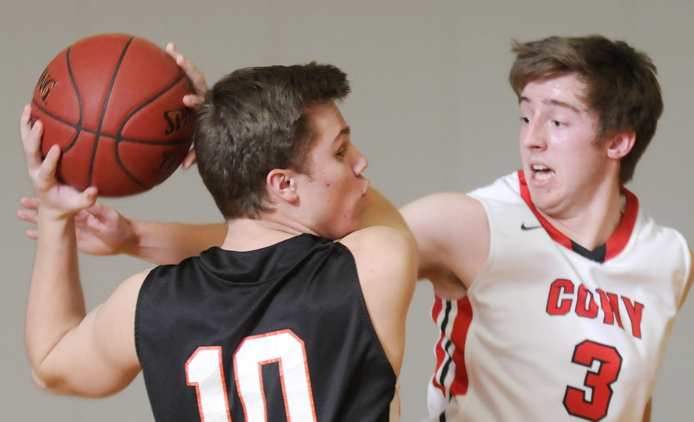 Cony High School’s Ben Leet, right, knocks the ball away from Brunswick’s Josh Dorr during a KVAC A game Tuesday night.