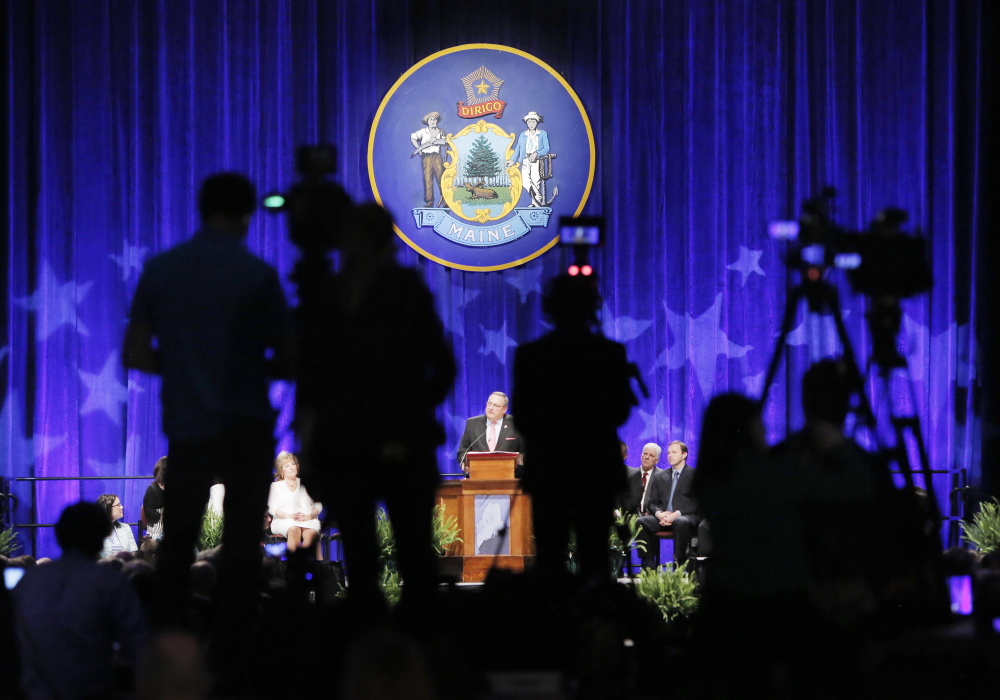Hidden by silhouettes of news videographers, Gov. Paul LePage delivers his inaugural address Wednesday at the Augusta Civic Center. The Republican promised – among other goals on his agenda – to reduce Maine’s public assistance program.