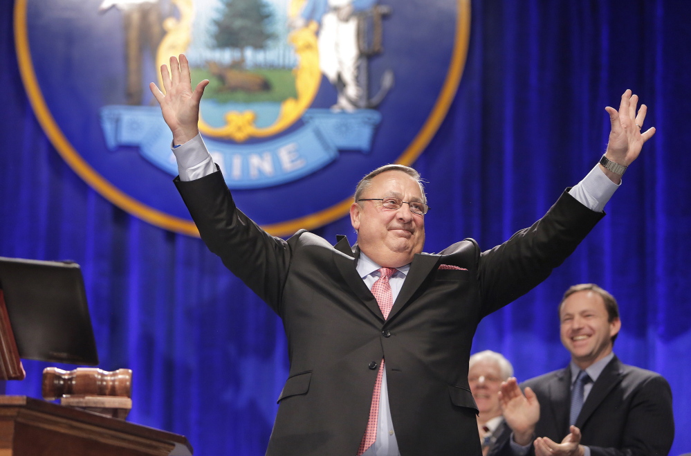 Gov. Paul LePage acknowledges cheers from the crowd during his inauguration Wednesday at the Augusta Civic Center. “The people of Maine ... want a smaller, more efficient state government,” Maine’s chief executive said as he embarked on his second four-year term.