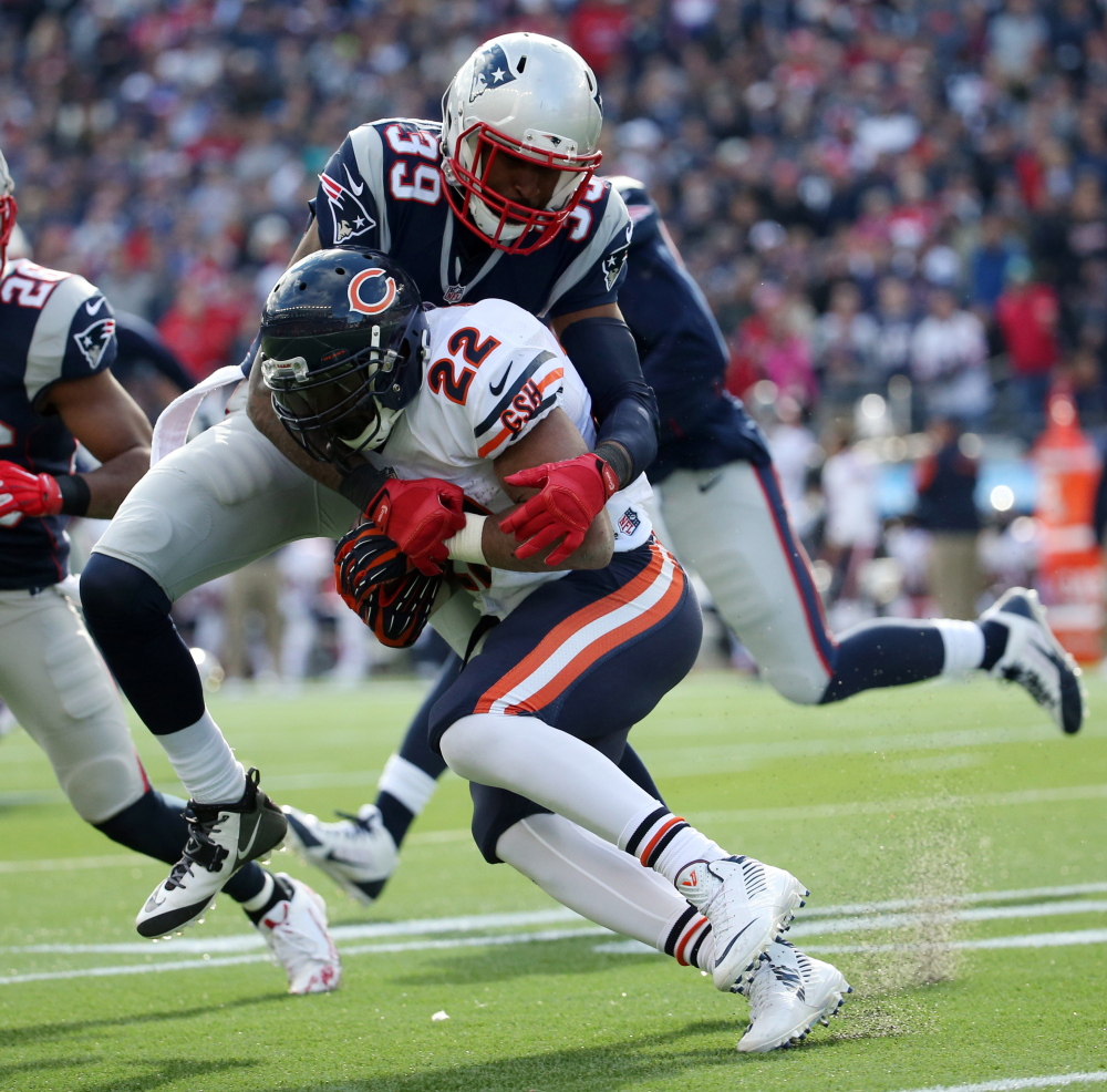 Chicago Bears running back Matt Forte (22) is tackled by New England Patriots cornerback Brandon Browner (39) in the second quarter during a recent game. The Patriots play the Baltimore Ravens on Saturday in the AFC divisional round.