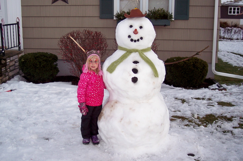 Addison Pelletier, 4, with the snowman that she and her father made recently in Augusta.  Submitted by Louise Pelletier 