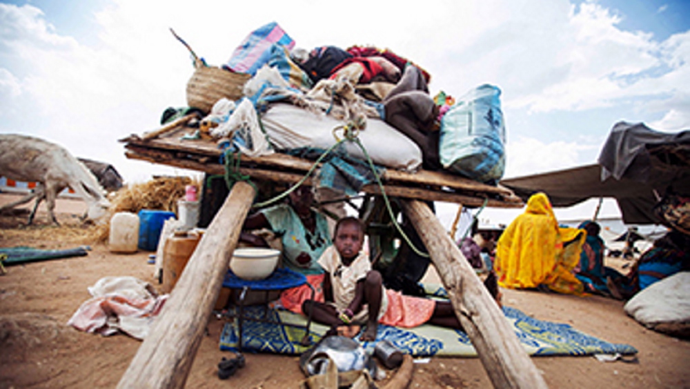 In this photo released by the United Nations African Union Mission in Darfur (UNAMID) last year, a Sudanese family takes shelter under their donkey cart at the Kalma refugee camp for internally displaced people, south of the Darfur town of Nyala, Sudan. At least 20, 000 have settled in refugee camps in Nyala. Women and children complain about the lack of food, water, and shelter. (AP photo/UNAMID, Albert Gonzalez Farran)