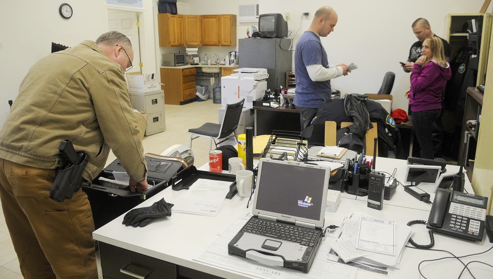 Monmouth Police officers unpack and organize their new station Thursday in Monmouth.