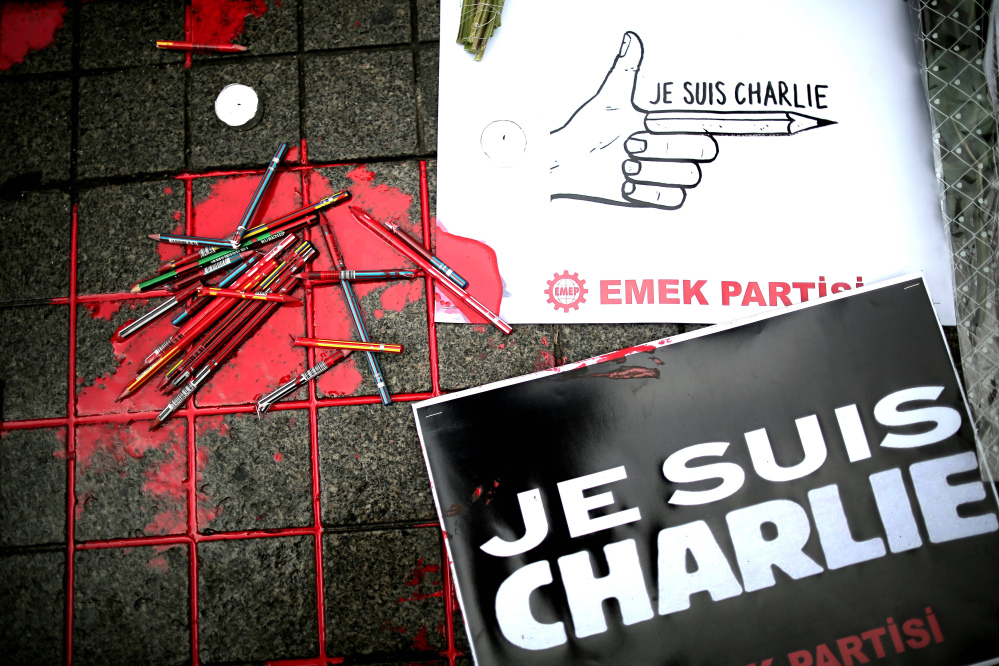 Broken pens and placards that read: “I am Charlie” lay on the ground as members of a leftist party gather outside the French consulate to pay tribute to the victims of the French satirical newspaper Charlie Hebdo, in Istanbul, Turkey, Friday.