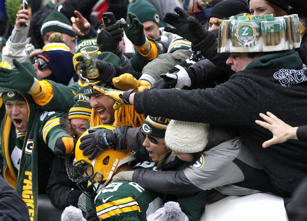 Green Bay Packers tight end Richard Rodgers (89) celebrates a touchdown with fans during the second half of an NFL divisional playoff football game against the Dallas Cowboys Sunday in Green Bay, Wis.