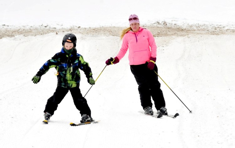 On Sunday, Bradie Castonguay of Waterville and her son, Ethan, ski down a trail at Eaton Mountain Ski and Snowtubing resort in Skowhegan on the second day in nearly a decade that skiing has been available.
