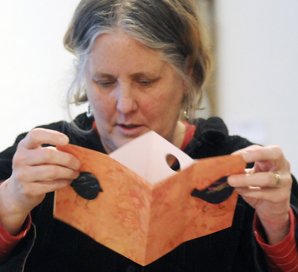 Maryanne McKinnon folds a book during a class at Harlow Gallery in Hallowell on Sunday.