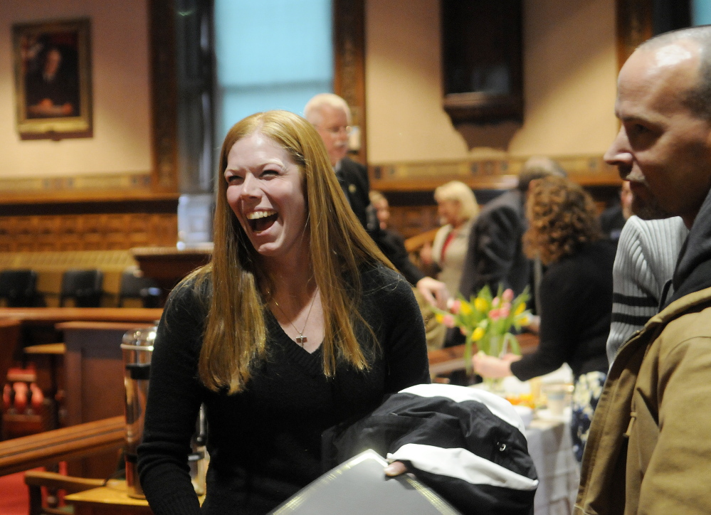 Jennifer Higgins laughs Monday after graduating from the Co-Occuring Disorders Court in Augusta.  Higgins was one of 14 people who completed the intensive program administered at Kennebec County Superior Court by Justice Nancy Mills.