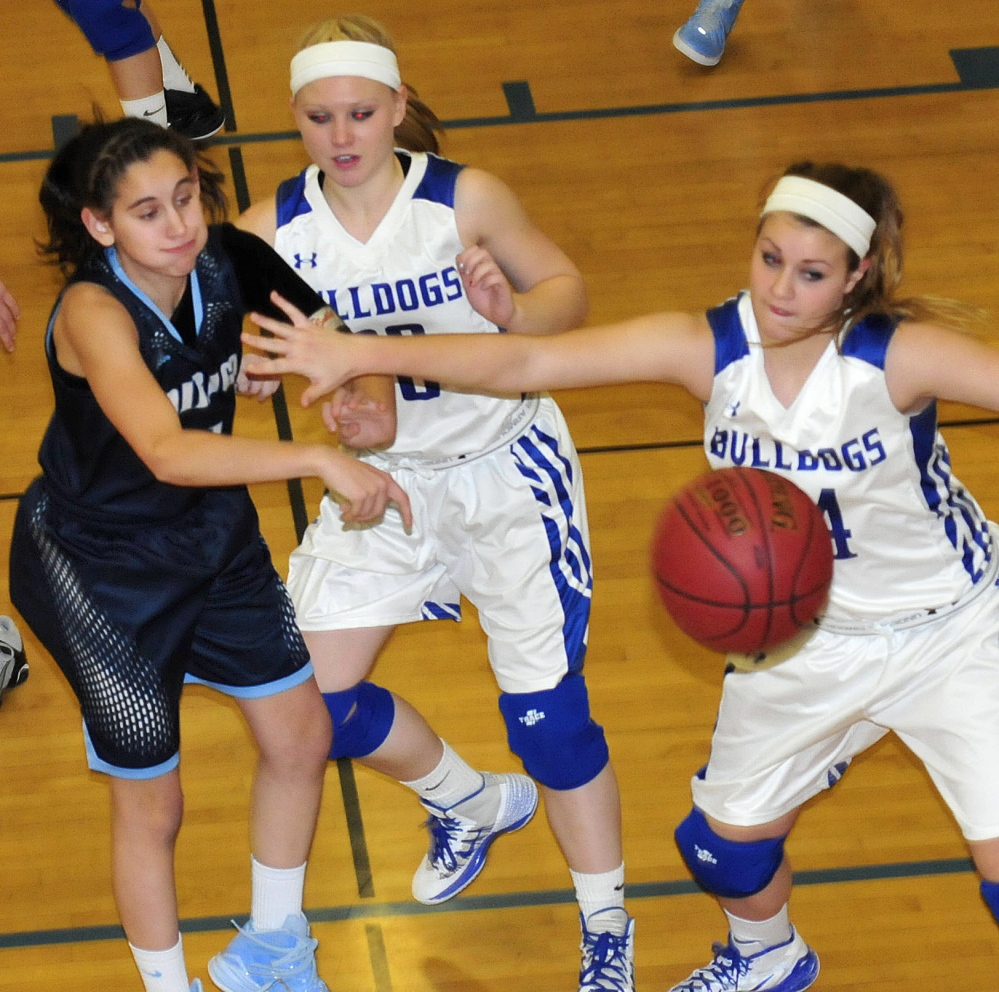 Madison’s Erin Whalen, right, and Dirigo’s Emma Lueders battle for ball during game Monday in Madison. Madeline Wood is at center. Dirigo won 55-47.