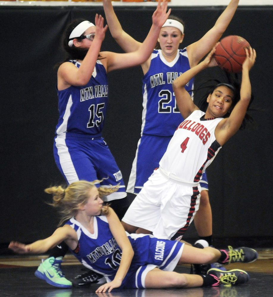 Hall-Dale High School’s Dani Sweet comes up with the ball while being surrounded by Mountain Valley High School defenders during a game Monday in Farmingdale.