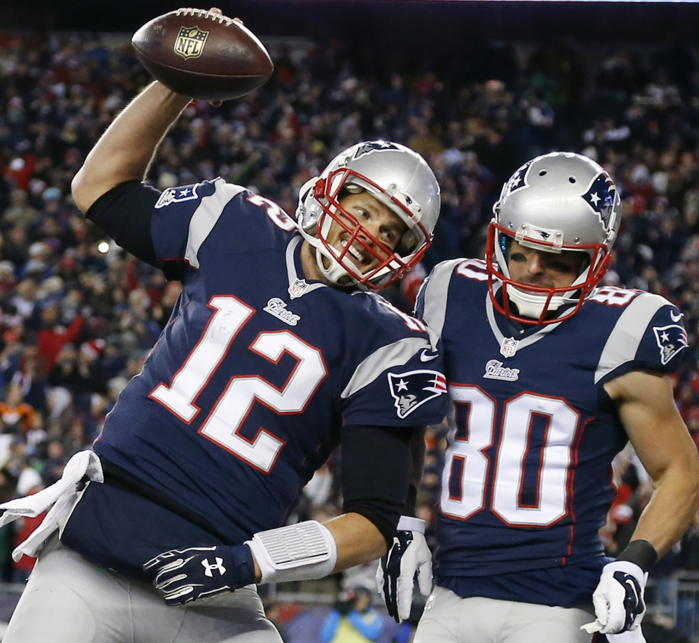 New England Patriots quarterback Tom Brady celebrates with wide receiver Danny Amendola in the first half of a recent game in Foxborough, Mass. All four teams in this weekend’s conference championships navigated a winding road.