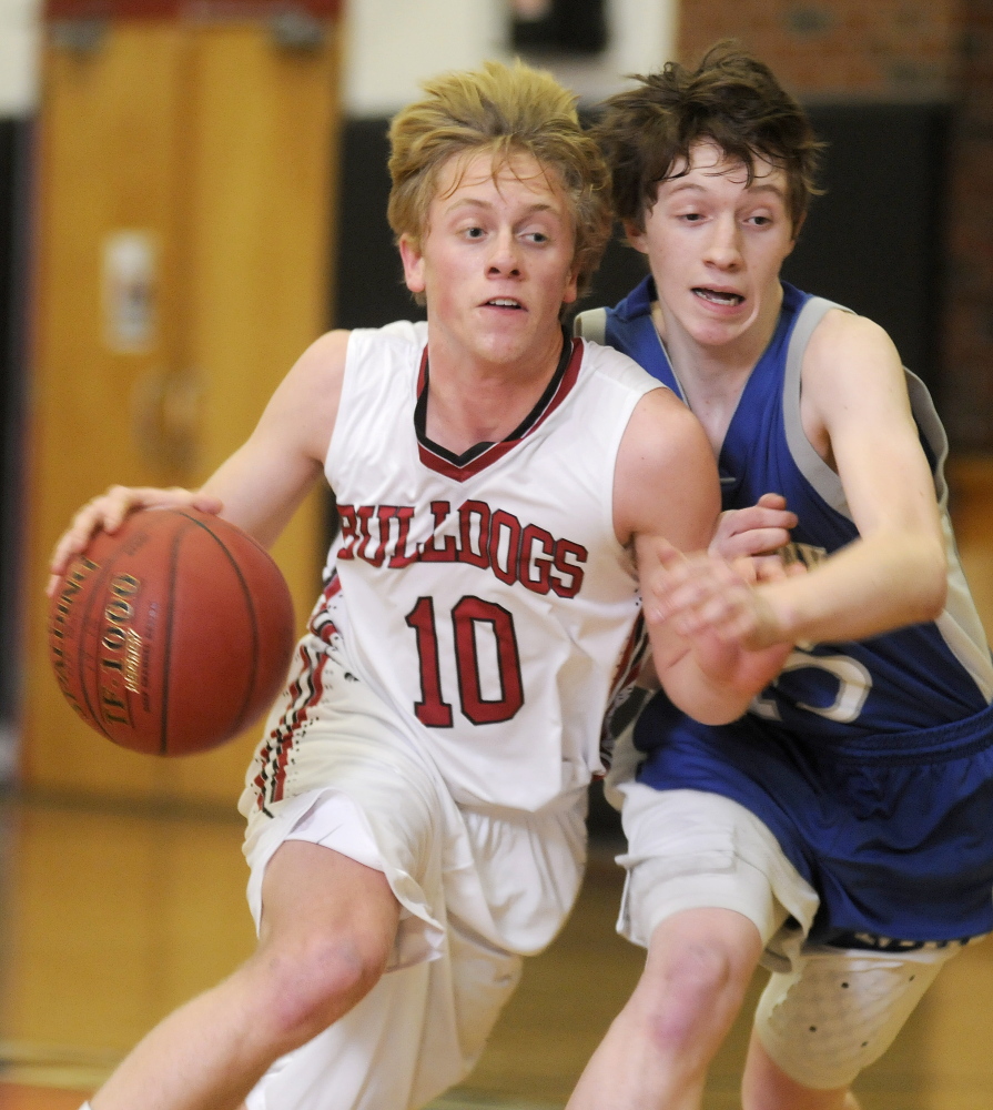 Hall-Dale High School’s Nat Crocker, left, maneuvers around Mountain Valley High School’s Alex Ridley during a Mountain Valley Conference game Tuesday night.