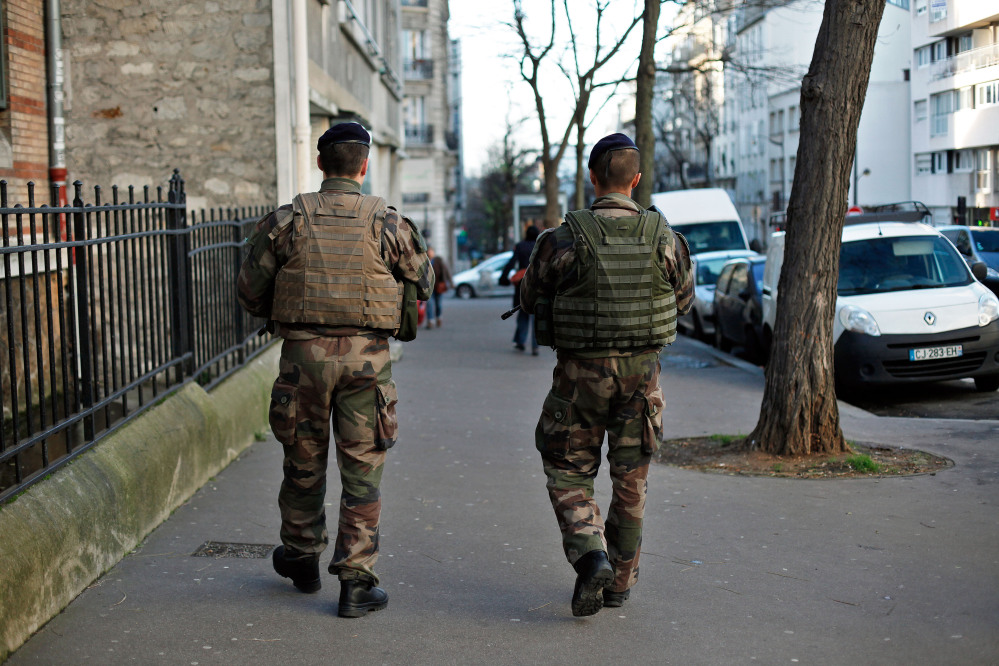 French soldiers secure the perimeter of a Jewish school in Paris on Wednesday as part of the highest level of security after last week’s attacks by Islamist militants. France has deployed thousands of police and soldiers around the country.