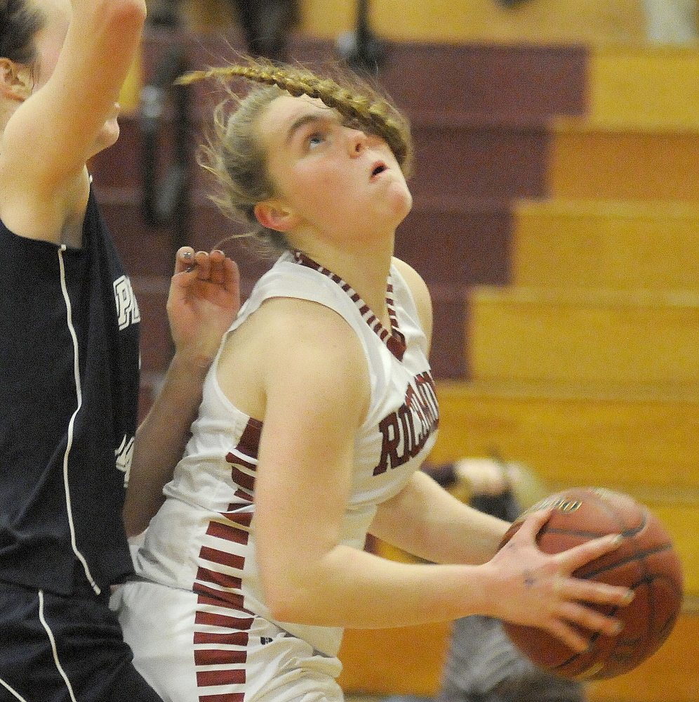 Richmond High School’s Sydney Tilton, right, looks for as Pine Tree Academy’s Kim Emerson defends Wednesday in Richmond.