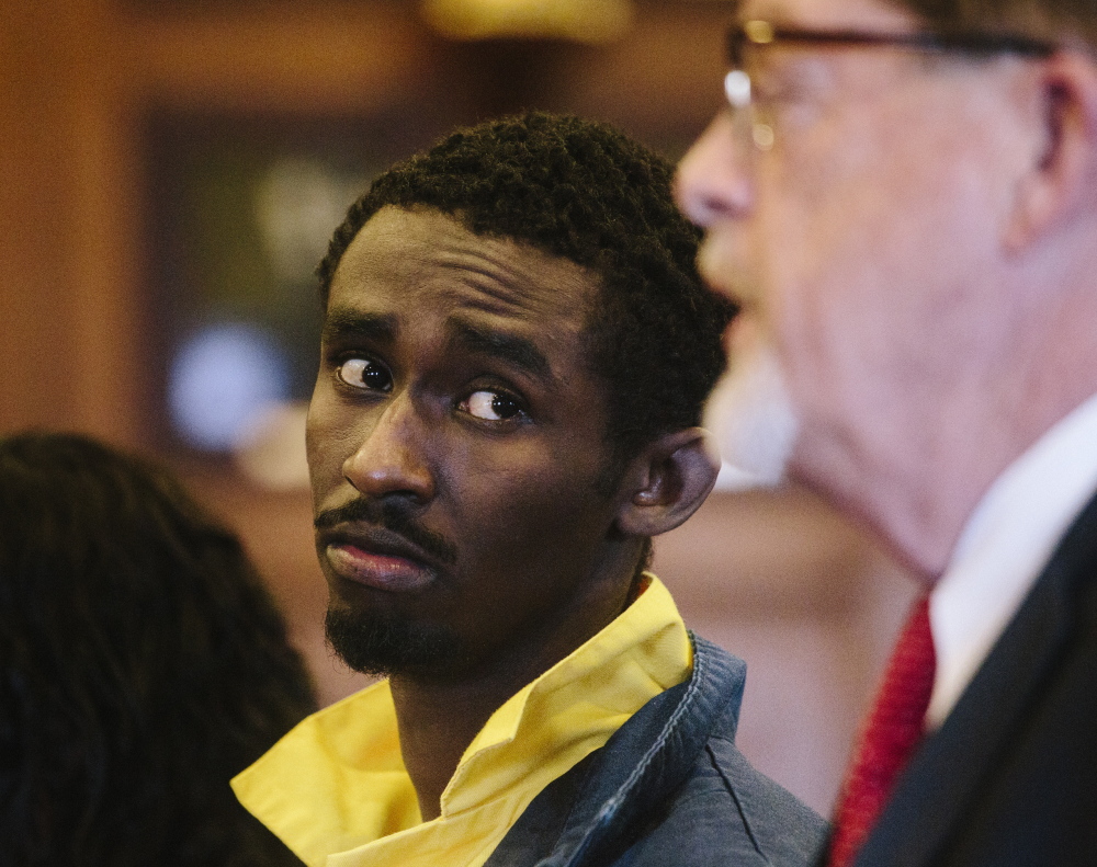 Abdirahman Huessin Haji-Hassan looks at defense attorney Clifford Strike while he speaks to Justice Nancy Mills at his first court appearance Thursday in Portland.