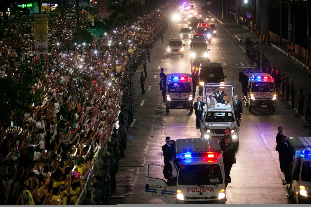 A huge crowd of Filipino faithful gather in excitement along Roxas Boulevard in Manila, Philippines, as they welcome the motorcade of Pope Francis, who arrived on Thursday to begin his Apostolic visit.