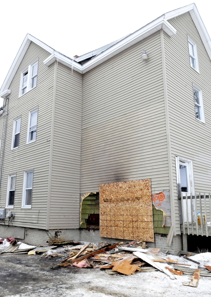 Damage from fire can be seen in the rear section of an apartment building at 28 Bellevue Street in Winslow on Thursday.