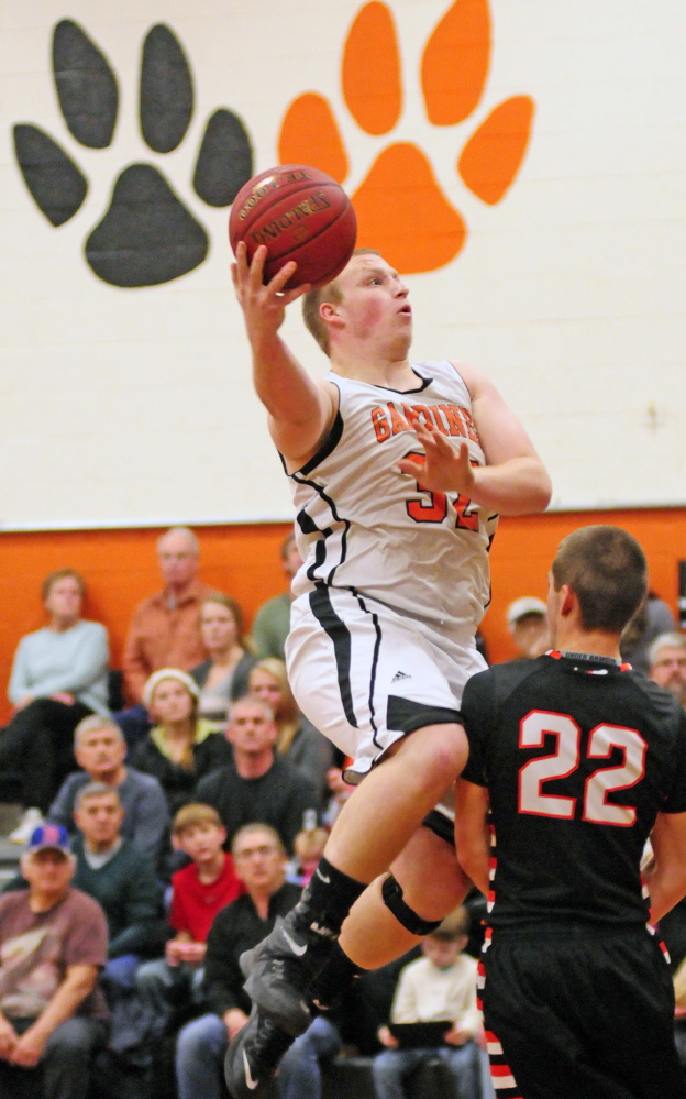 Staff file photo by Joe Phelan 
 Gardiner's Brad Weston, left, goes up for a shot against Winslow's Josh Kervin during a Kennebec Valley Athletic Conference Class B game last month.