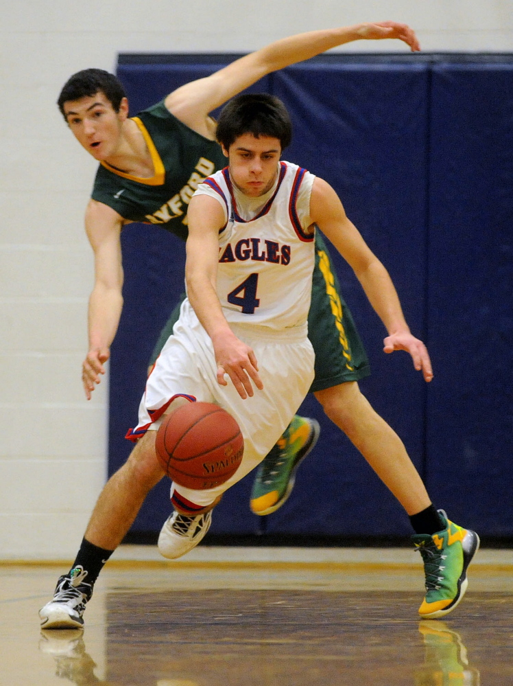 Messalonskee’s Kyle LaFreniere (4) steals the ball from Oxford Hills’ Tyus Ripley during a Kennebec Valley Athletic Conference Class A game Friday night.